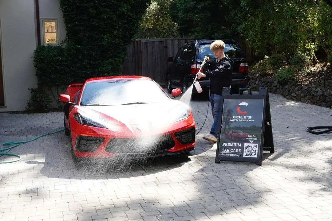Ceramic coating being applied to a dark painted panel with an applicator block
