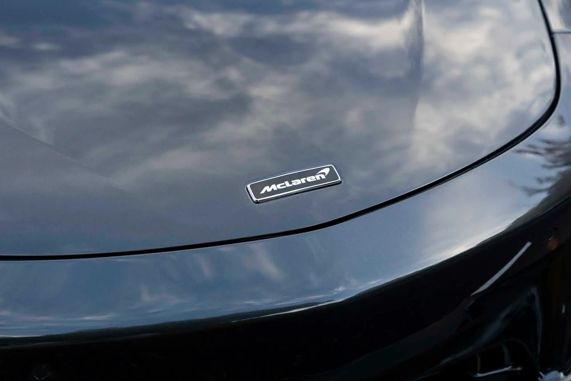 McLaren Artura hood badge with cloud reflections