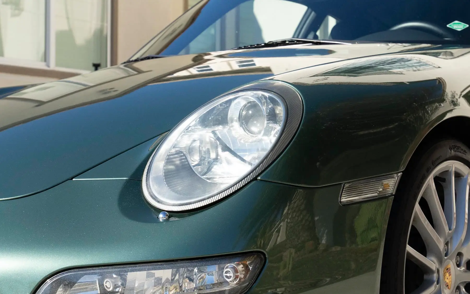 The same Porsche 911 headlight, restored and crystal clear