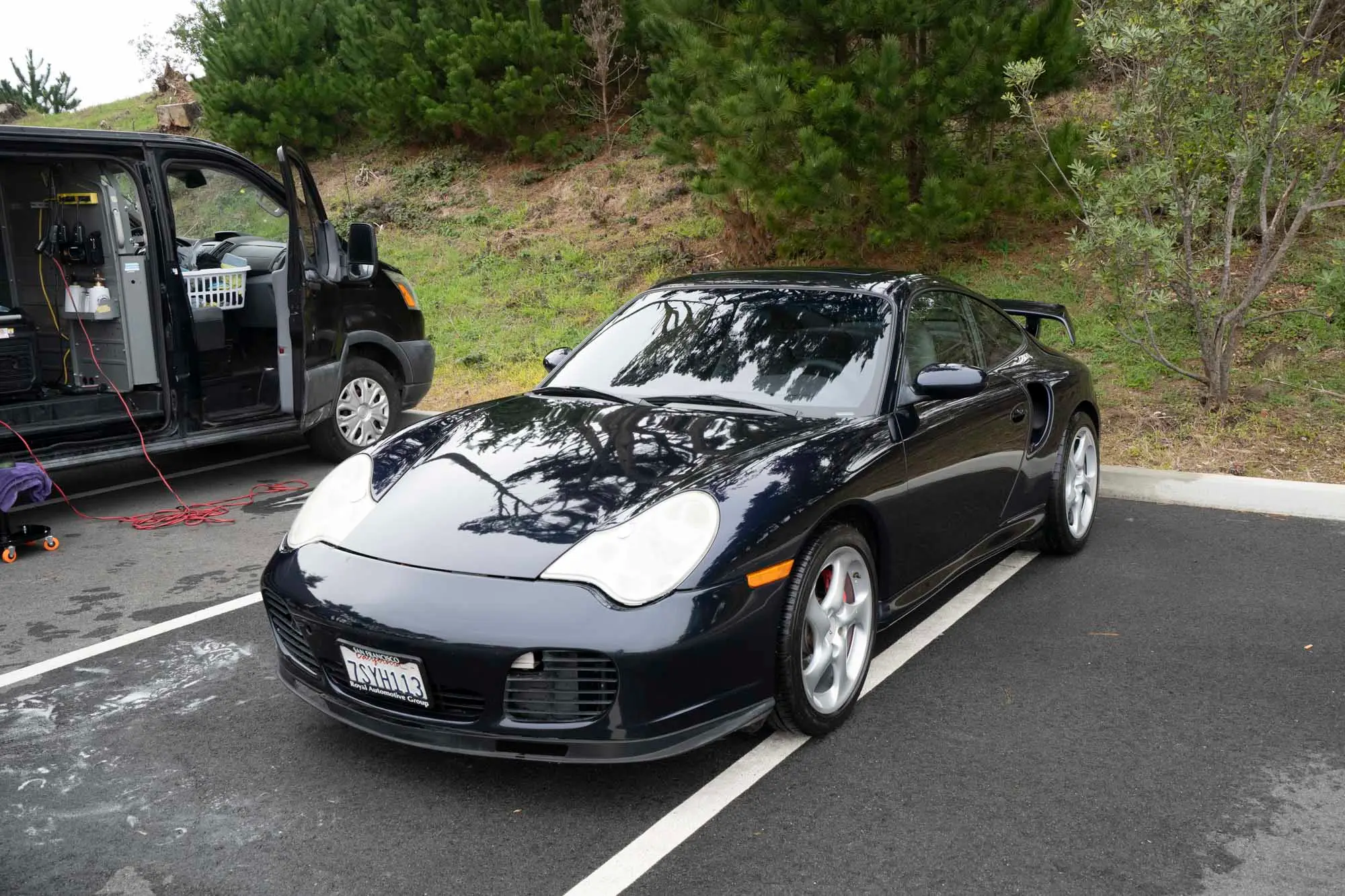 Porsche 911 beside the fully loaded Cole’s work van