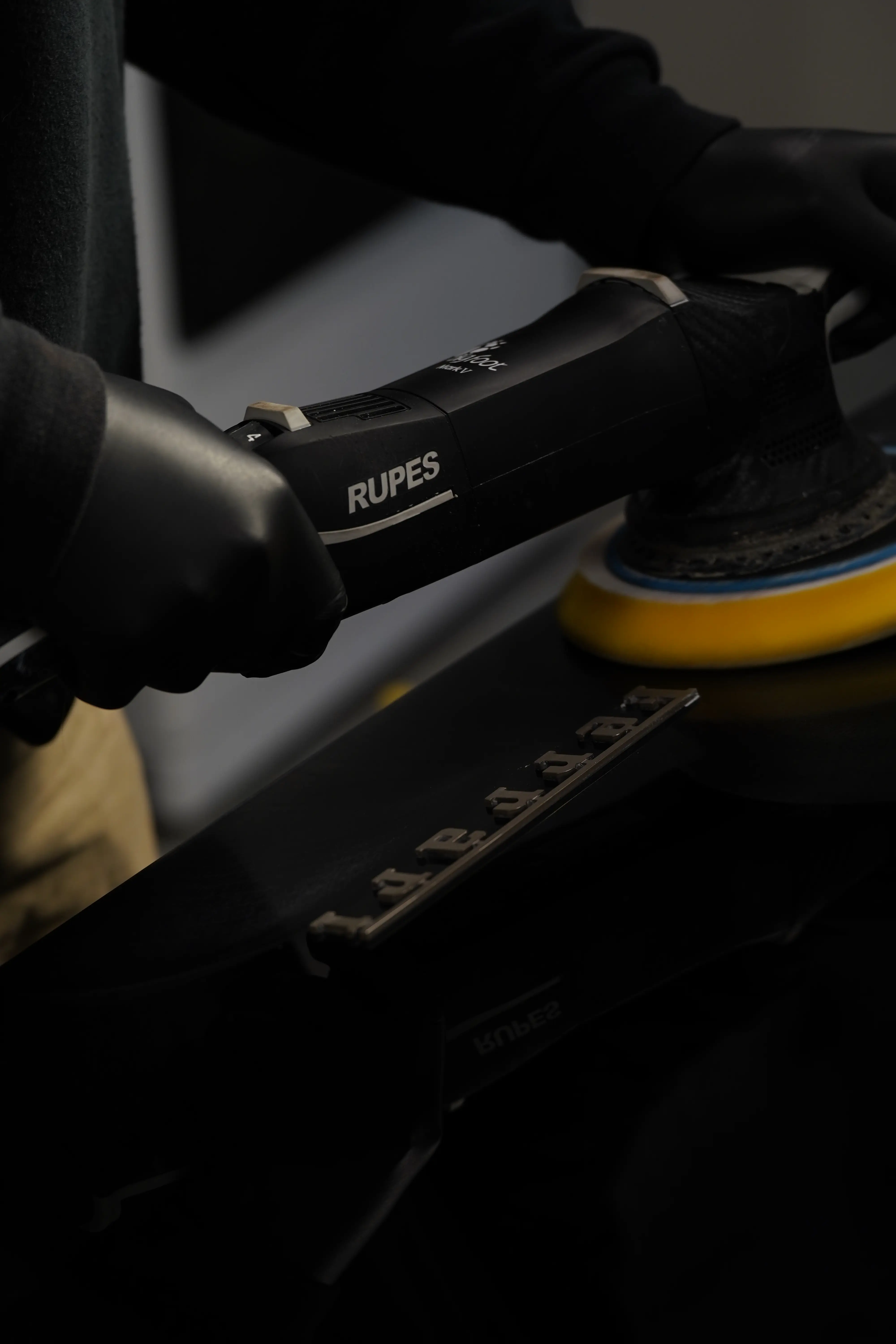 Compounding stage on black Ferrari paint