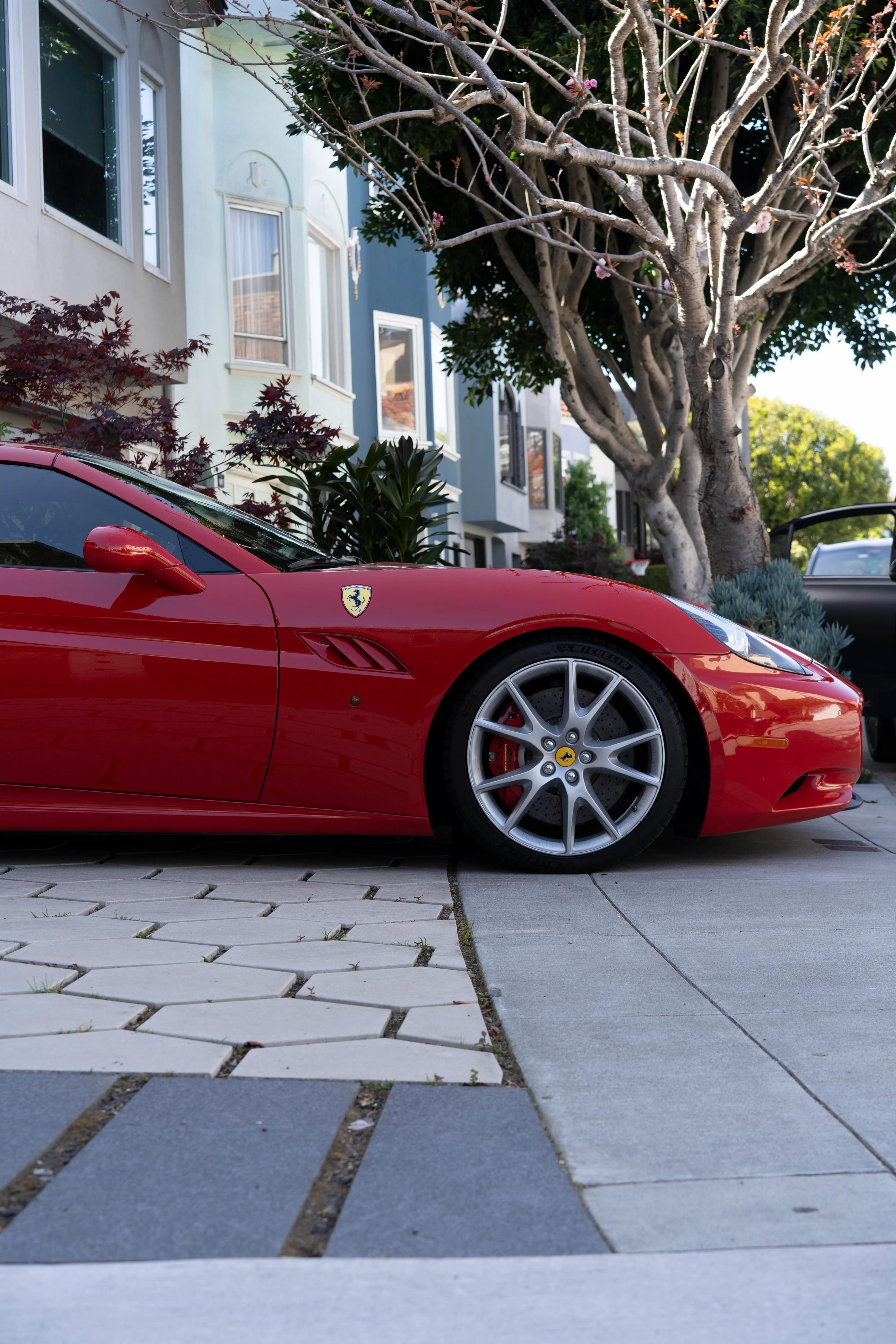 Freshly detailed red Ferrari California parked on a San Francisco street