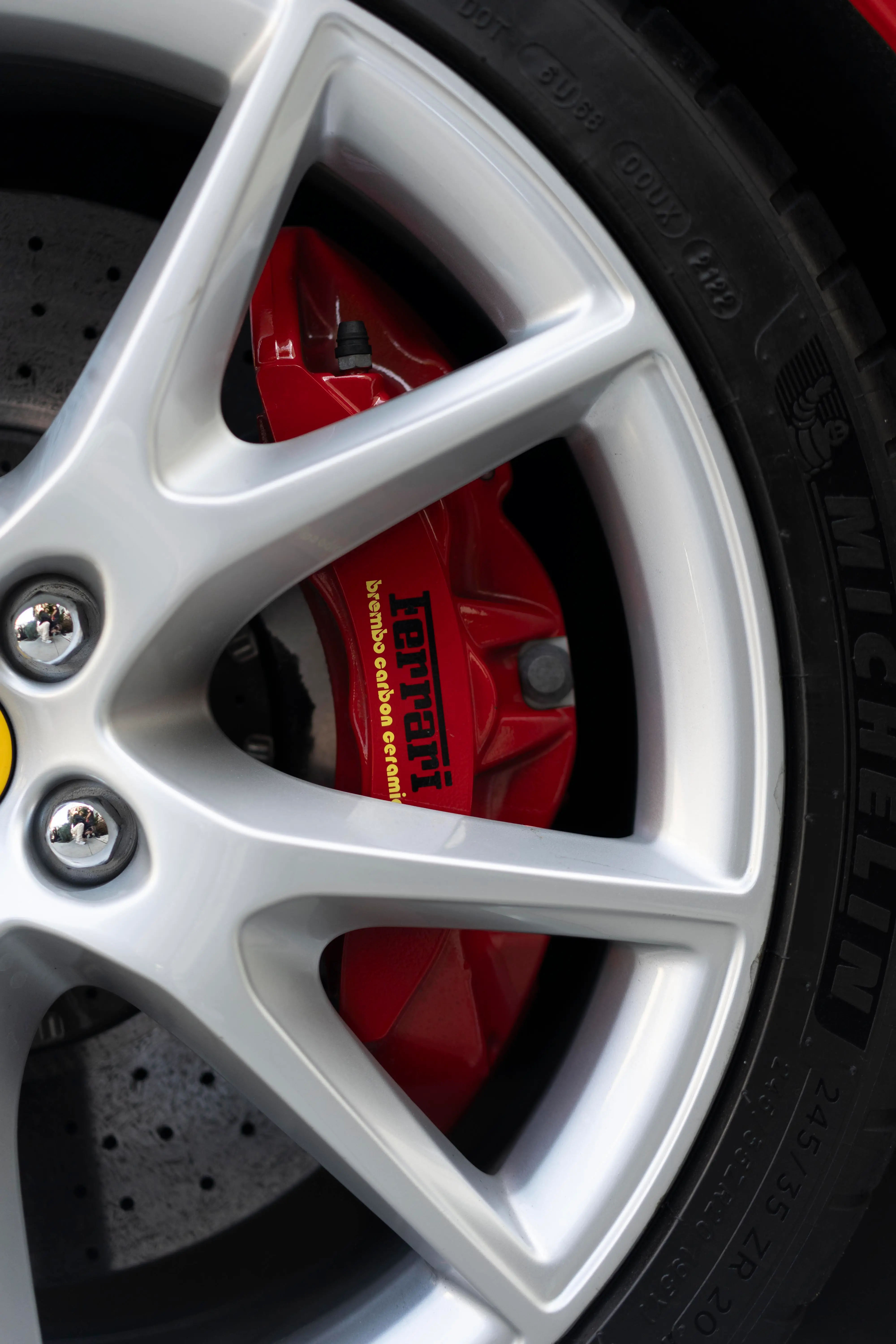 Polished Ferrari wheel and red brake caliper