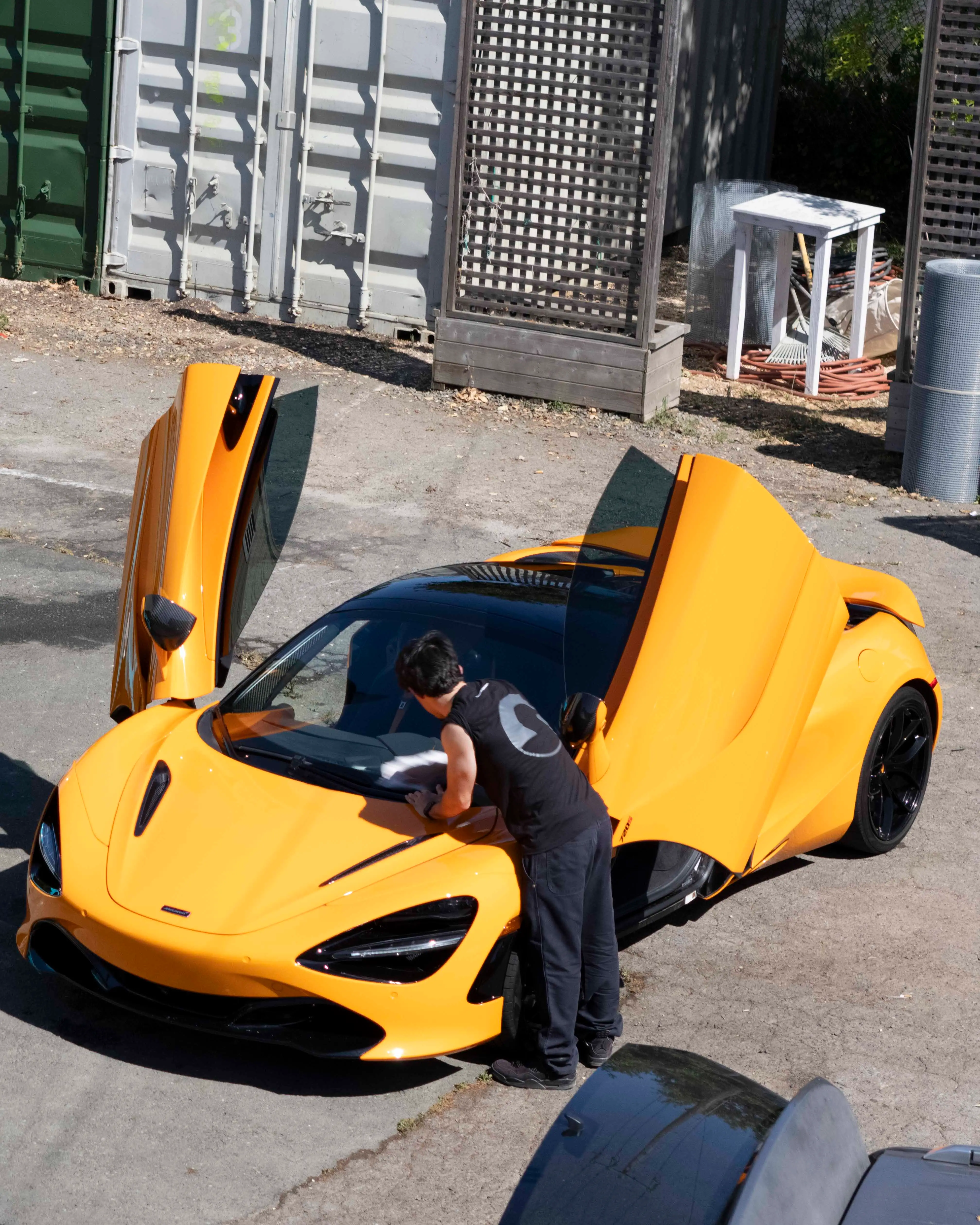 Yellow McLaren 720S with doors up during a detail