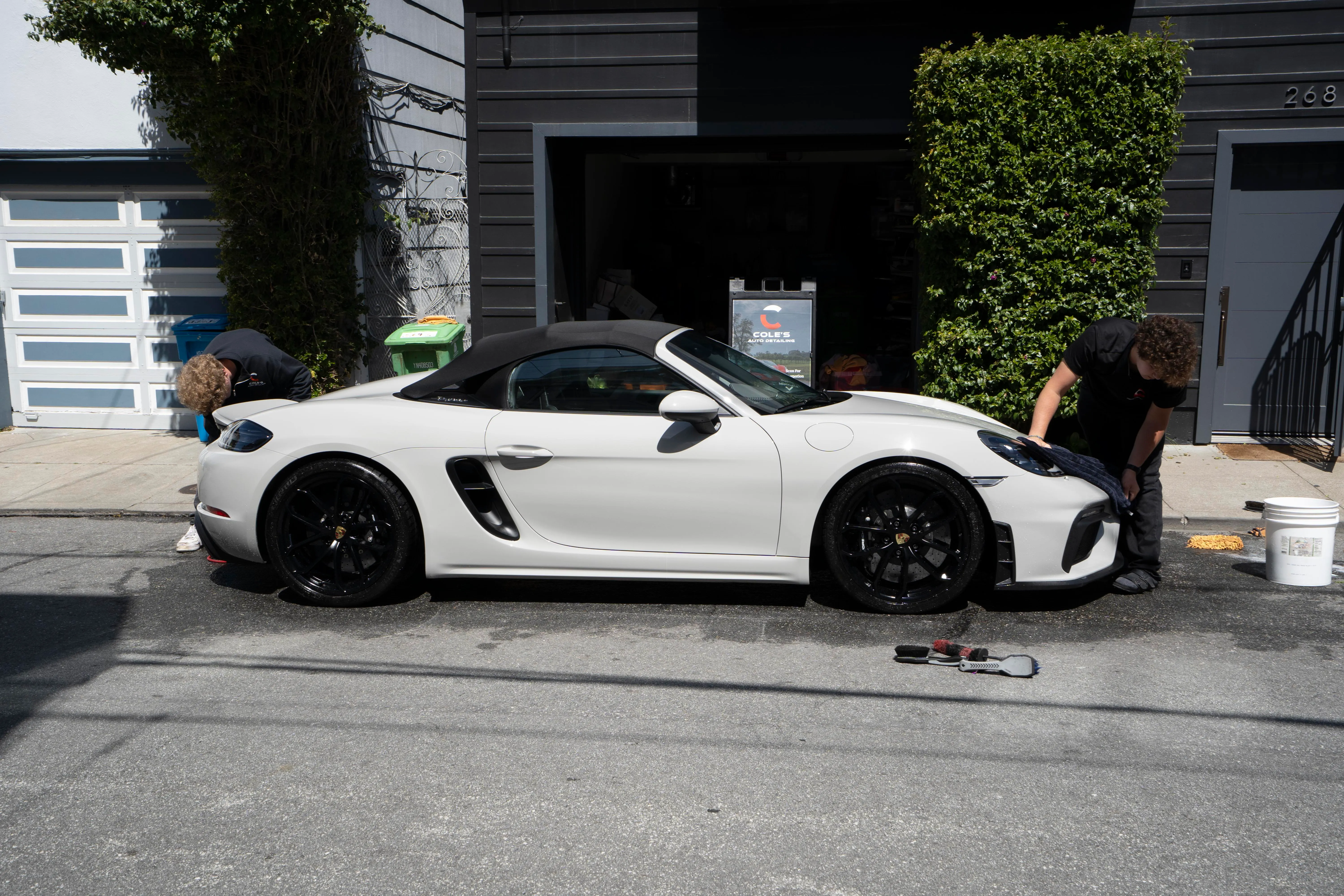 Cole’s crew mid-detail on a white Porsche 718 Spyder