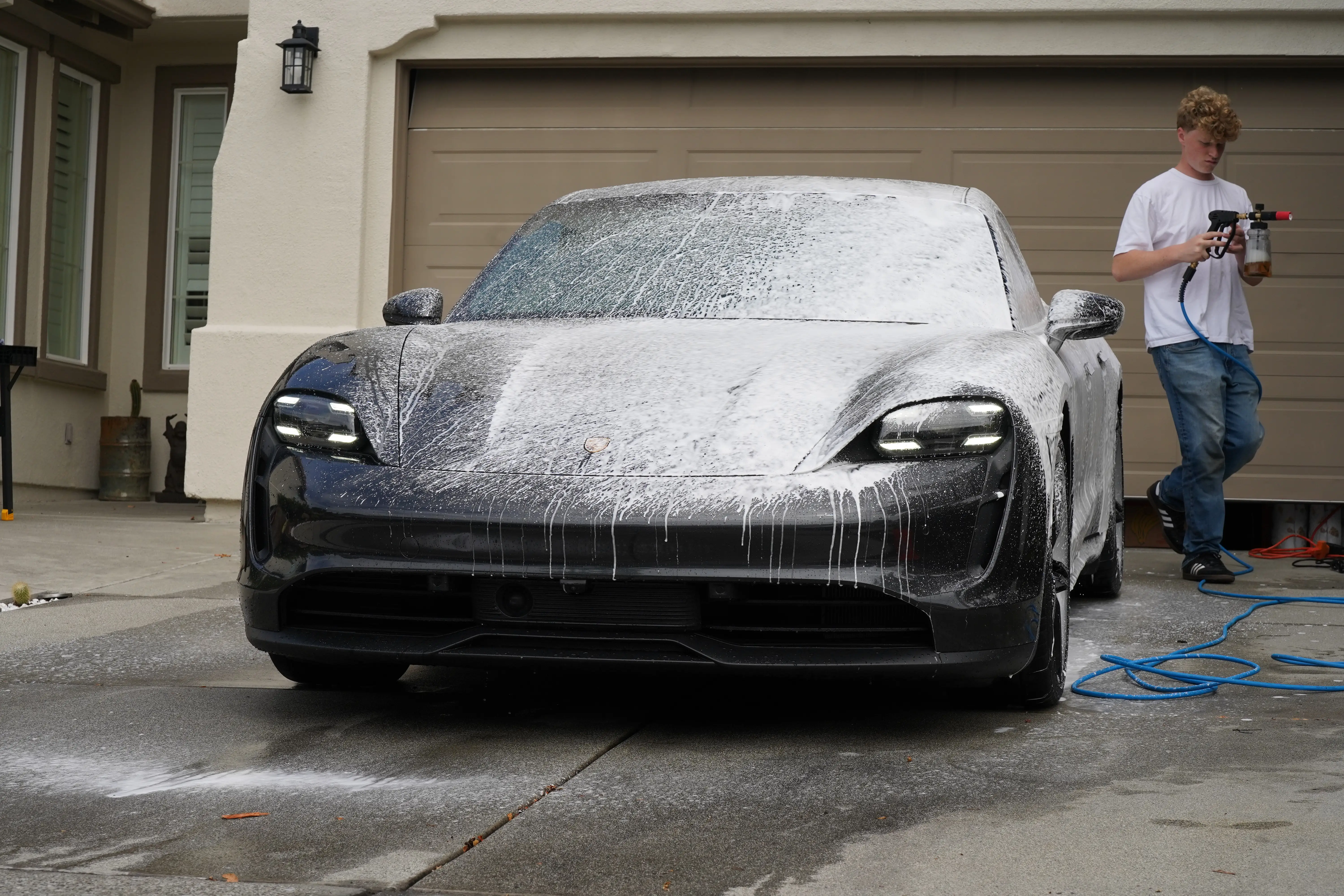 Porsche Taycan covered in foam during a detail