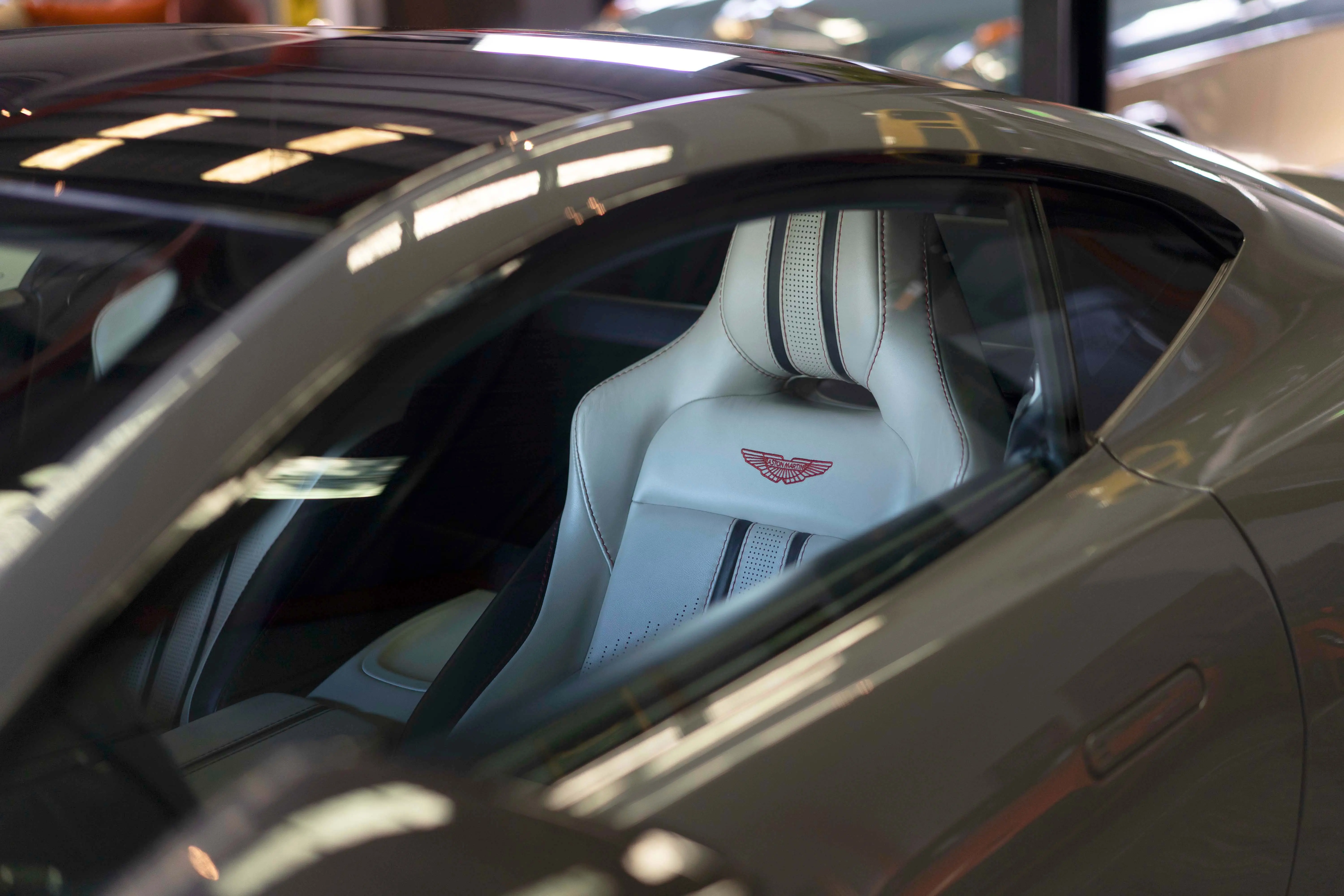 Aston Martin seat with red-stitched wings after an interior detail