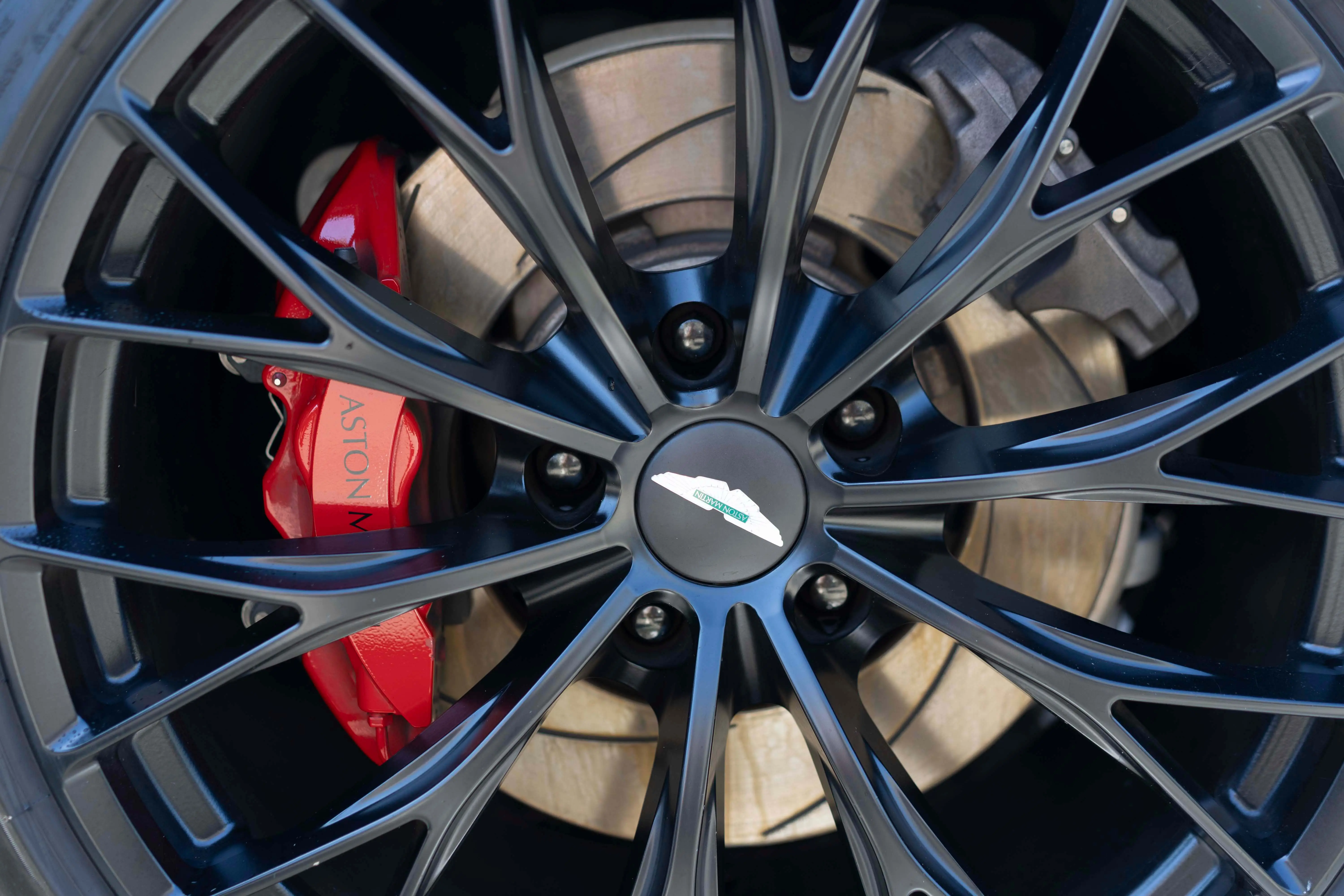 Aston Martin wheel with red calipers after detailing