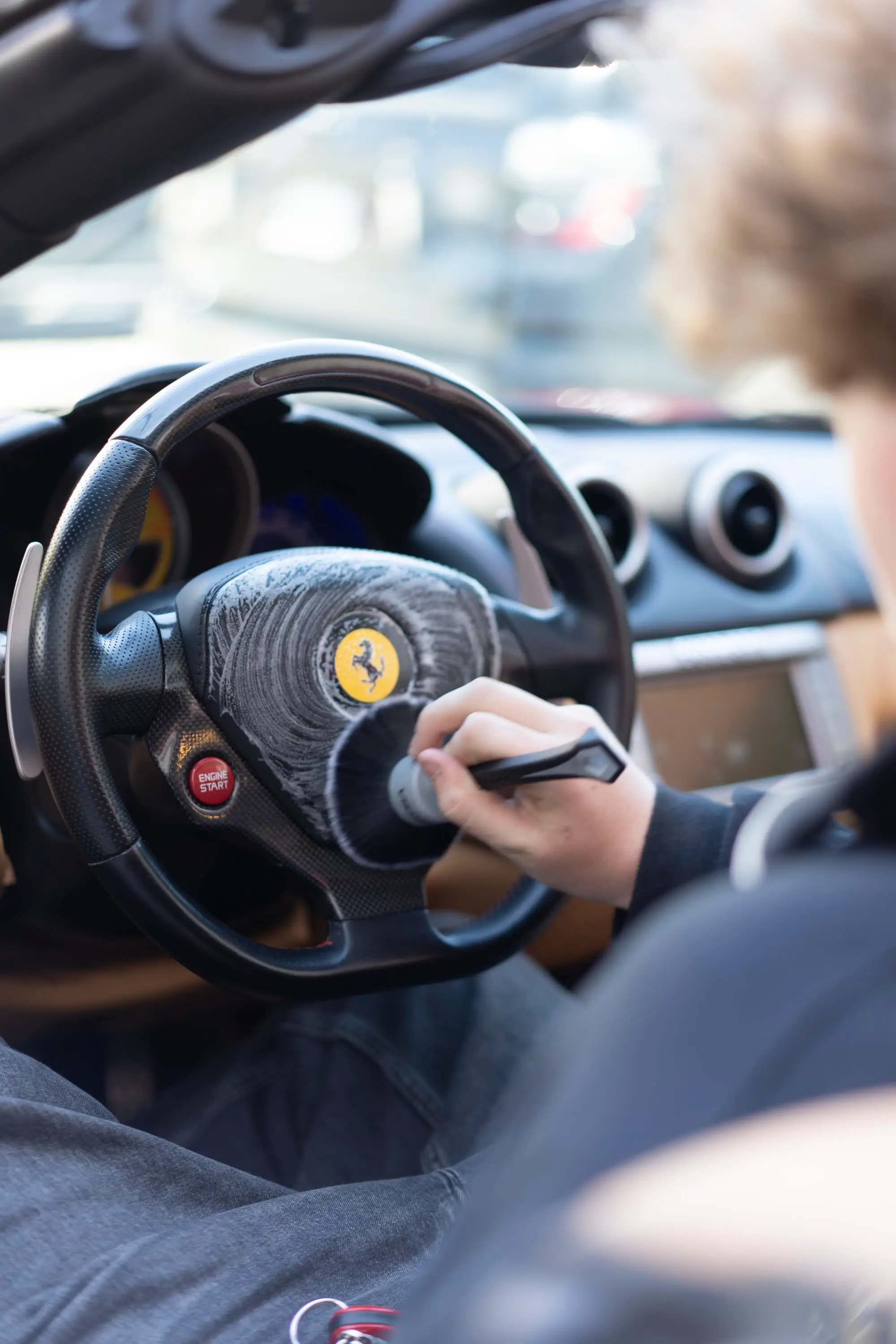 Ferrari California, Detailer brush-cleaning Ferrari steering wheel with foaming cleaner