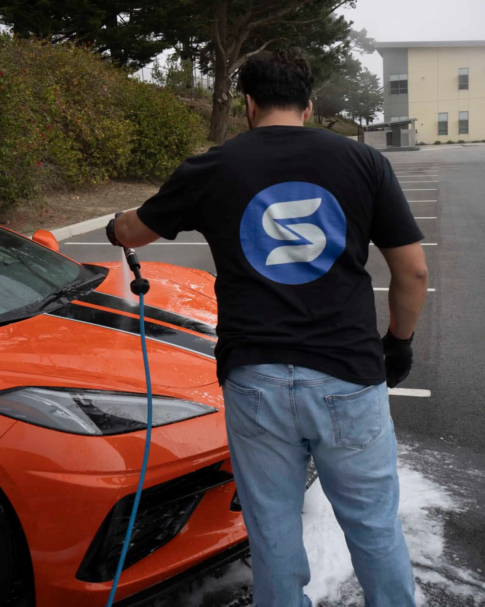 Detailer rinsing Corvette C8 hood